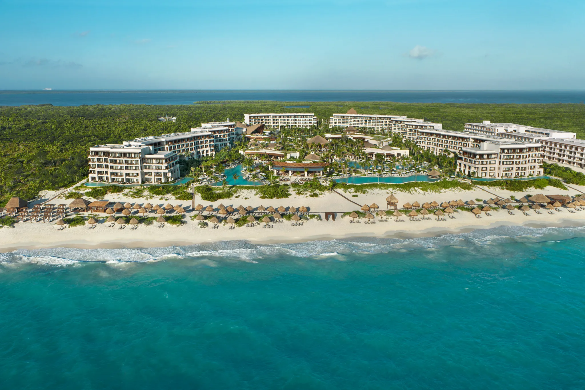 Aerial view of Secrets Playa Mujeres luxury resort with infinity pool and Caribbean ocean